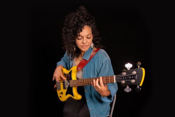 Professor Suzanne Galal playing a bass guitar.