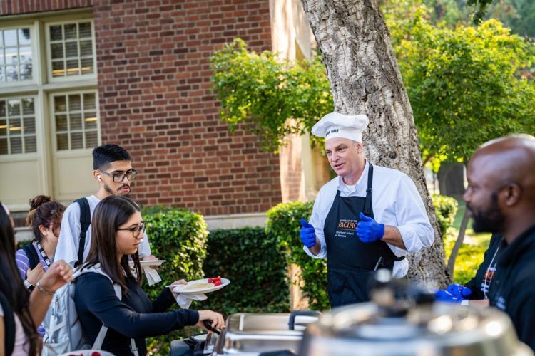 Eberhardt School of Business students are treated to "pancakes with the dean" during Week of Welcome in 2023. 