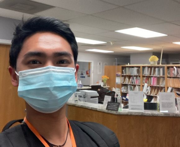 an pre-health student wearing a mask in a health-professions waiting room